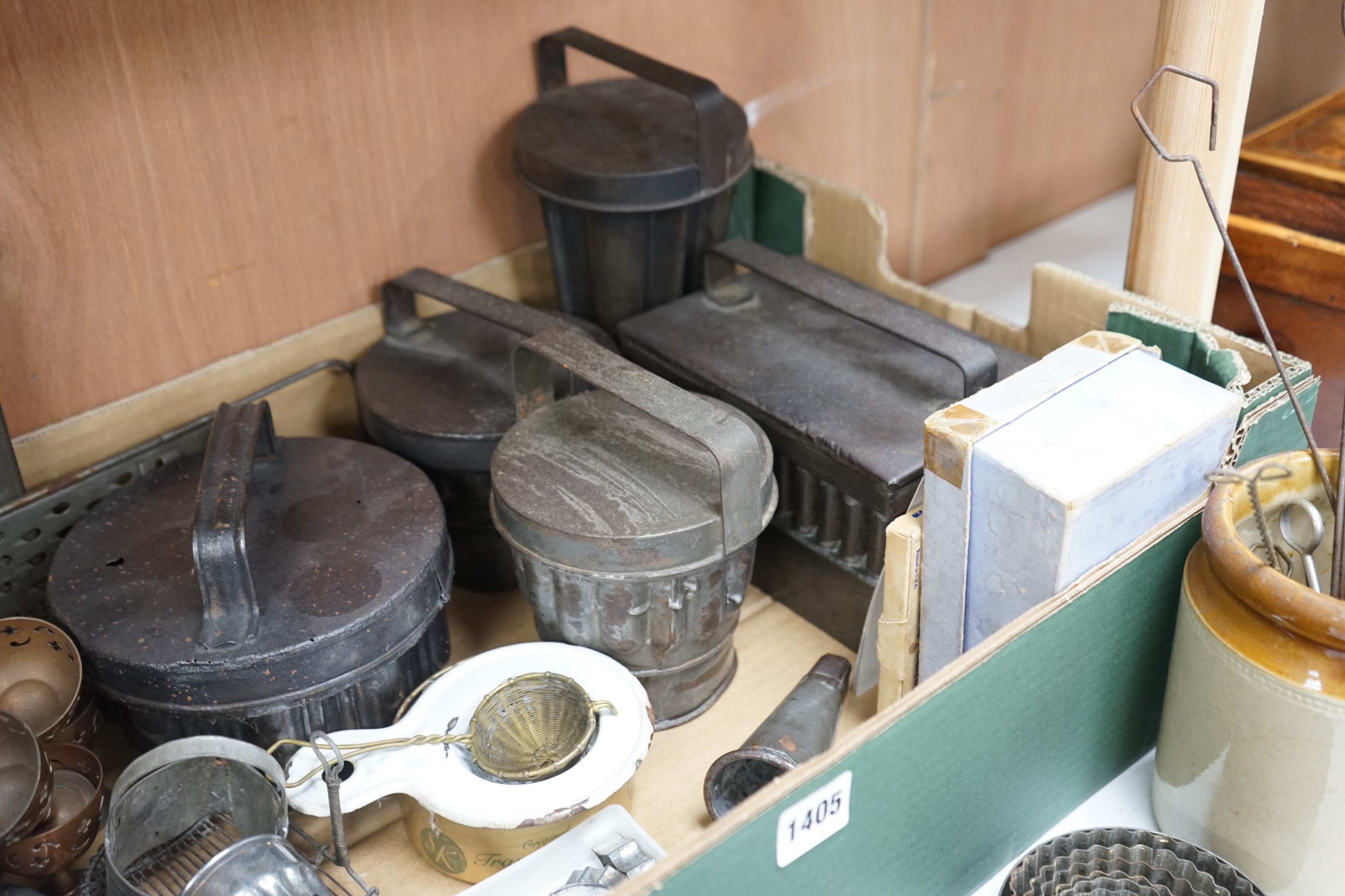 A good collection of tin plated iron jelly moulds, pastry moulds and kitchenalia